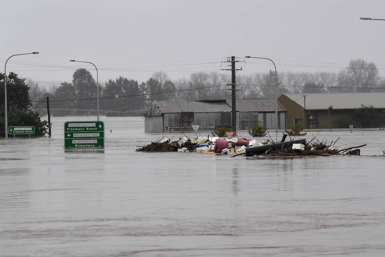 Debris is seen as the the Windsor Bridge is submerged under floodwater from the swollen Hawkesbury River, in Windsor, north west of Sydney, Monday, July 4, 2022.