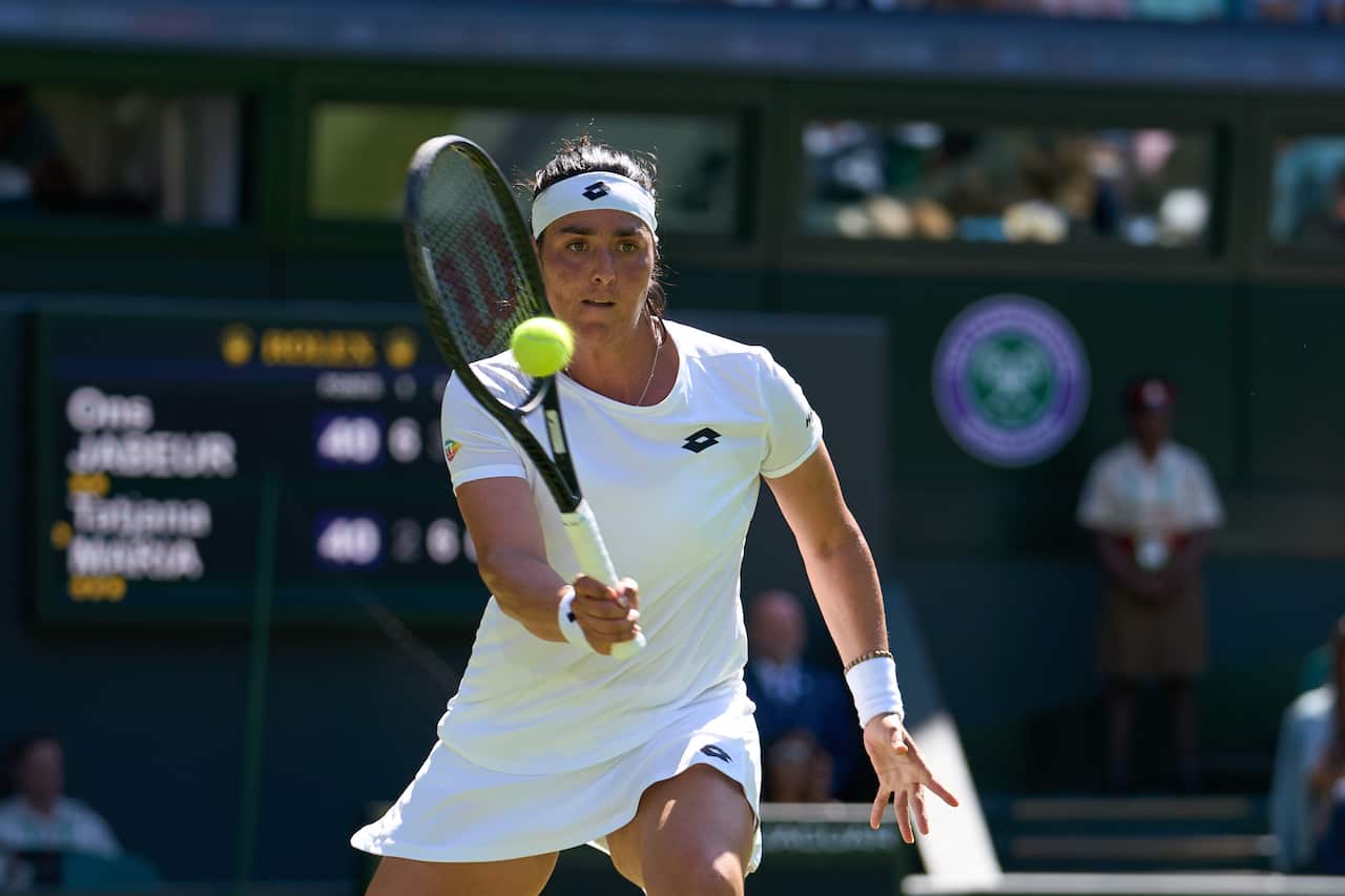 Jul 7, 2022, London, England, United Kingdom, Ons Jabeur (TUN) returns a shot during her semi-finals womens singles match against Tatjana Maria (GER) on Centre court at All England Lawn Tennis and Croquet Club. Mandatory Credit: Peter van den Berg-USA T