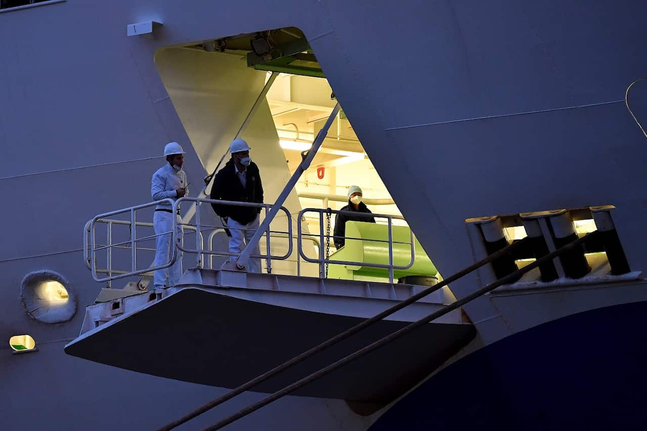 Crew members are seen onboard The Coral Princess cruise ship as it docks at Circular Quay in Sydney, Wednesday, July 13, 2022.