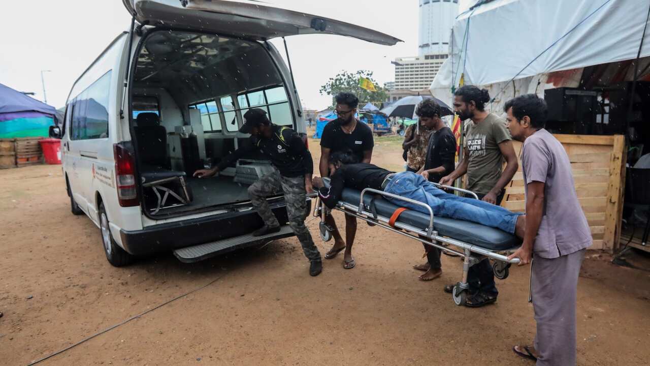 A medical team carries an injured protester into an ambulance after Sri Lankan Army soldiers forcibly evicted protesters from the President's secretariat premises, in Colombo, Sri Lanka, 22 July 2022.