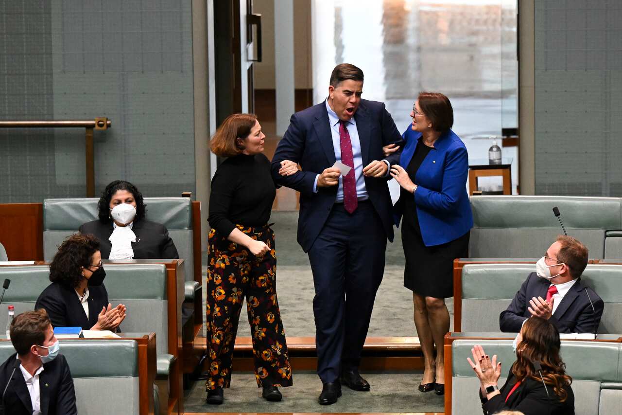 The member for Oxley Milton Dick is dragged to the speakers chair after being elected speaker in the House of Representatives during the opening of the 47th Federal Parliament at Parliament House in Canberra, Tuesday, July 26, 2022. (AAP Image/Lukas Coch)