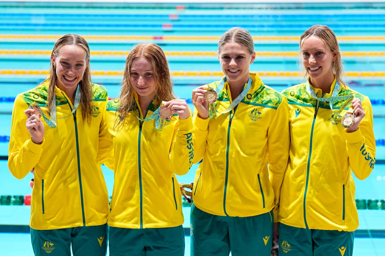 Swimmers of team Australia pose after winning the gold medal in the Women's 4x100 meters freestyle relay final during the Commonwealth Games at the Sandwell Aquatics Centre in Birmingham, England, Saturday, July 30, 2022. (AP Photo/Aijaz Rahi)