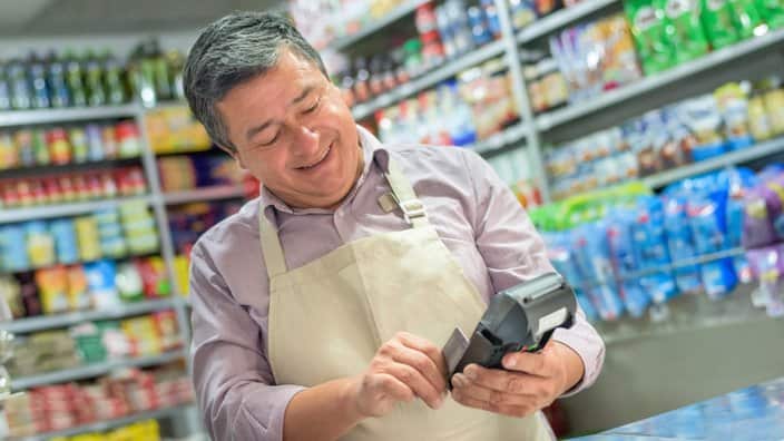 Small business owner using a credit card reader