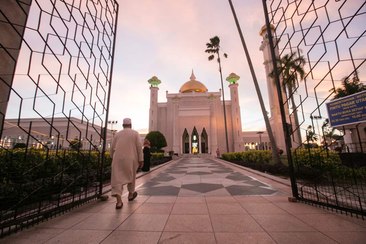 A Muslim man walks inside the Sultan Omar Ali Saifuddien mosque to perform the sunset prayer in Bandar Seri Begawan, Brunei.