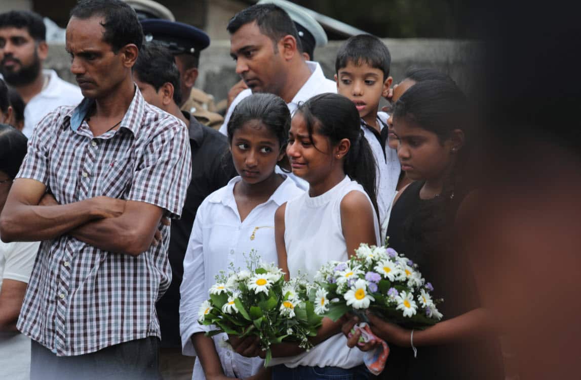 Friends of Dhami Brandy, 13, who was killed during Easter Sunday's bomb blast at St. Sebastian Church, cries during funeral service in Negombo, Sri Lanka Thursday, April 25, 2019 (AAP)