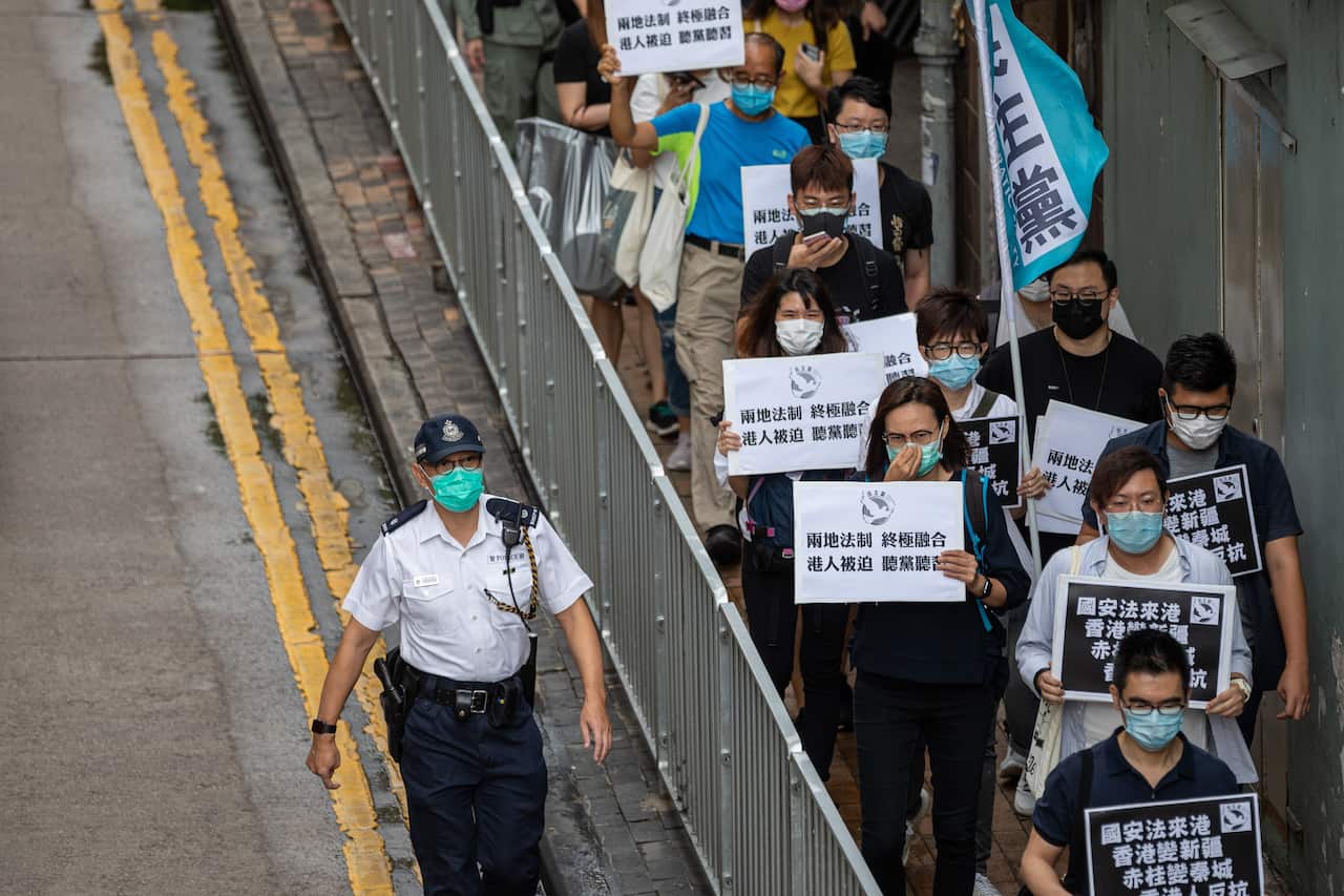 Pan-democrat lawmakers and activists make their way to Chinas Liaison Office during a rally against a security law in Hong Kong, China.
