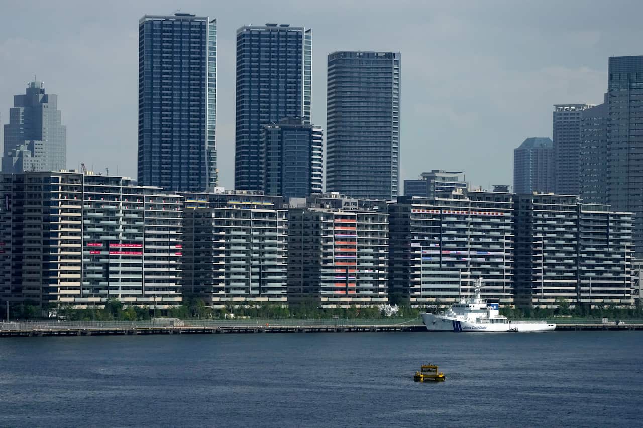 National banners hang from balconies at an athlete's village as Tokyo prepares for the 2020 Summer Olympics.