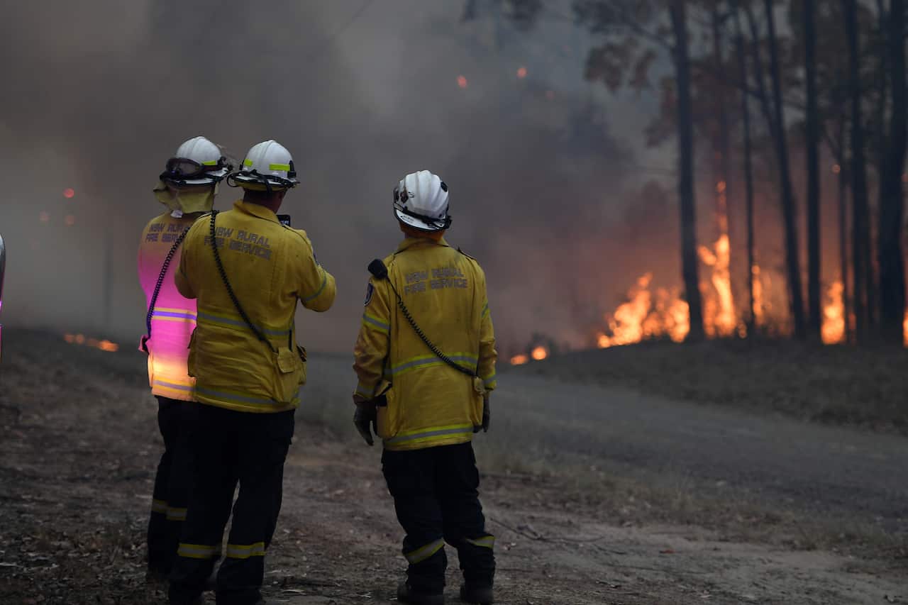 NSW Rural Fire Service crews fight a fire as it burns close to property on Wheelbarrow Ridge Road at Colo Heights, north-west of Sydney.