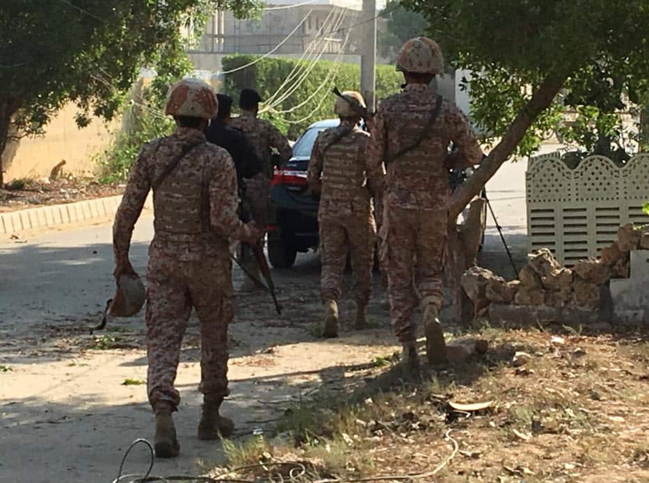 Paramilitary forces and police are seen during an attack on the Chinese consulate, where blasts and shots are heard, in Karachi, Pakistan November 23, 2018. 