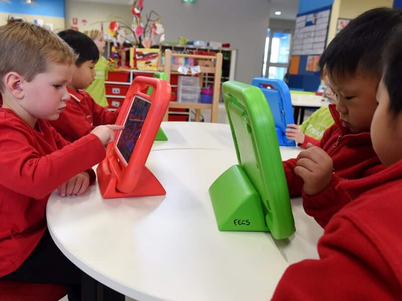 Kids play on iPads at Franklin Early Learning School in Canberra