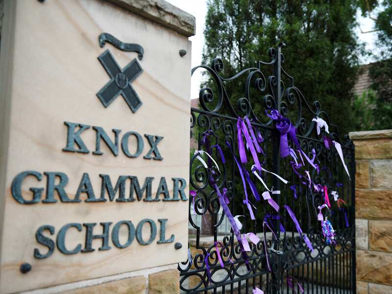 Purple ribbons are seen outside Knox Grammar School