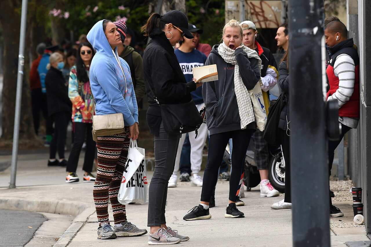 People are seen waiting in line at the Prahran Centrelink office in Melbourne