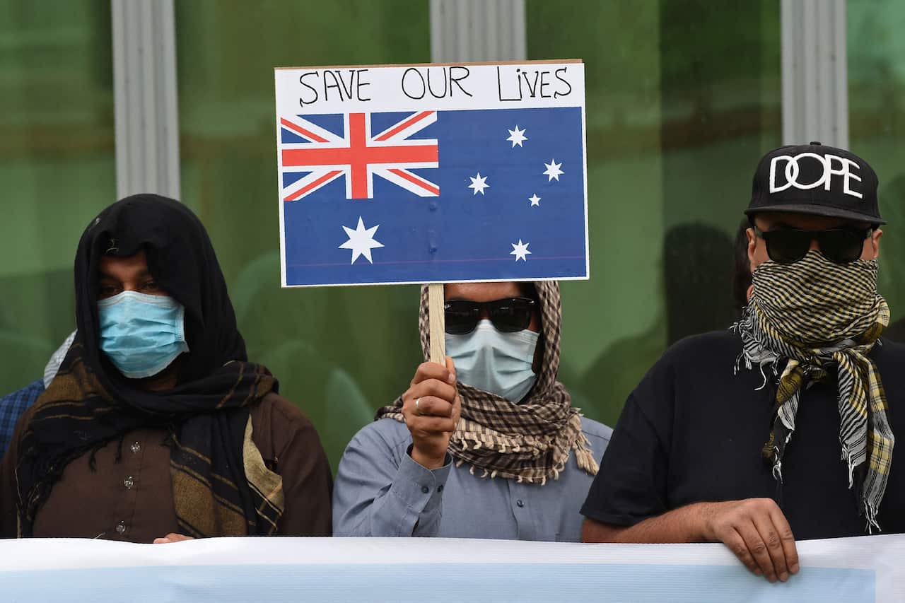 Afghan former interpreters for the US and NATO forces gather during a demonstration in downtown Kabul on April 30, 2021.