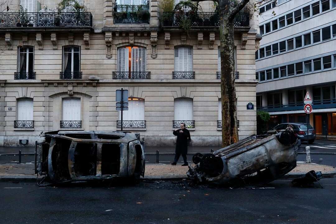 Charred cars the day after a demonstration, near the Arc de Triomphe, in Paris.