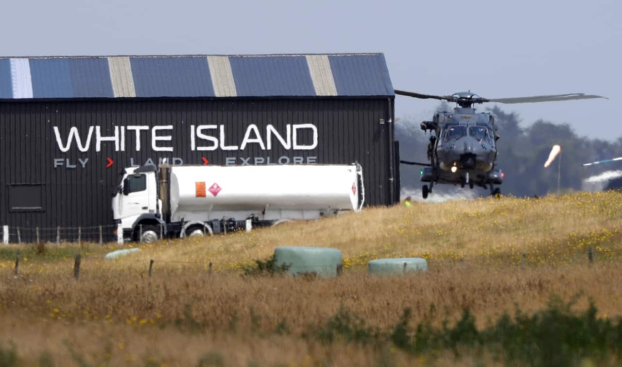 A Navy helicopter returns to Whakatane Airport following the recovery operation.