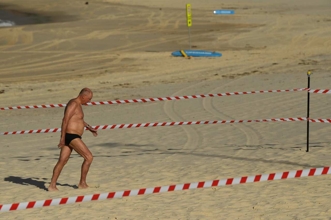 A swimmer leaves the water at Bondi Beach reopens to the public.
