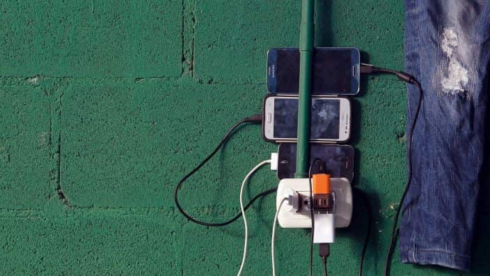 Cuban migrants charge their phones in a shelter in Costa Rica.
