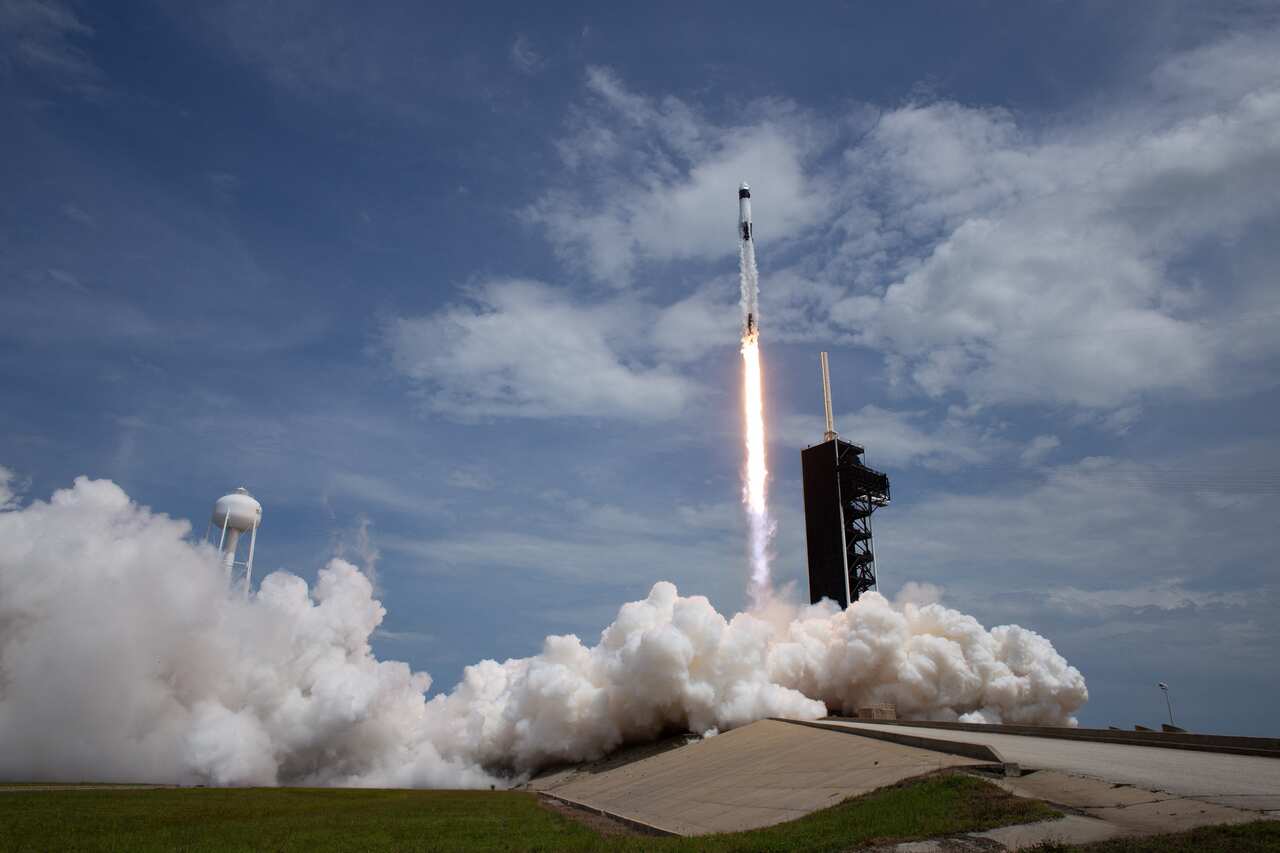SpaceX Falcon 9 rocket carrying the company's Crew Dragon spacecraft is launched from Launch Complex 39A.