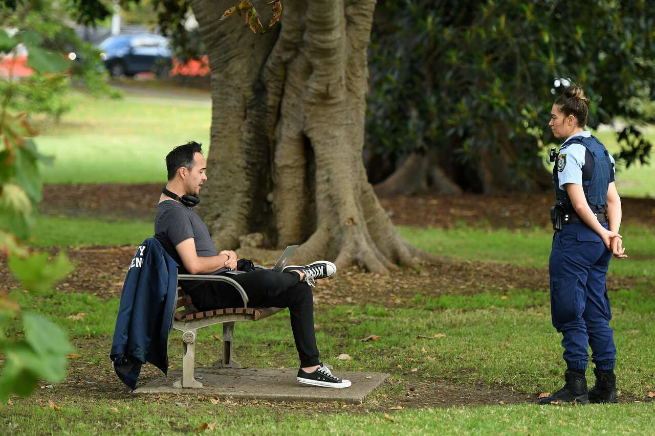 NSW Police officers ask people to move on while on patrol at Rushcutters Bay in April.