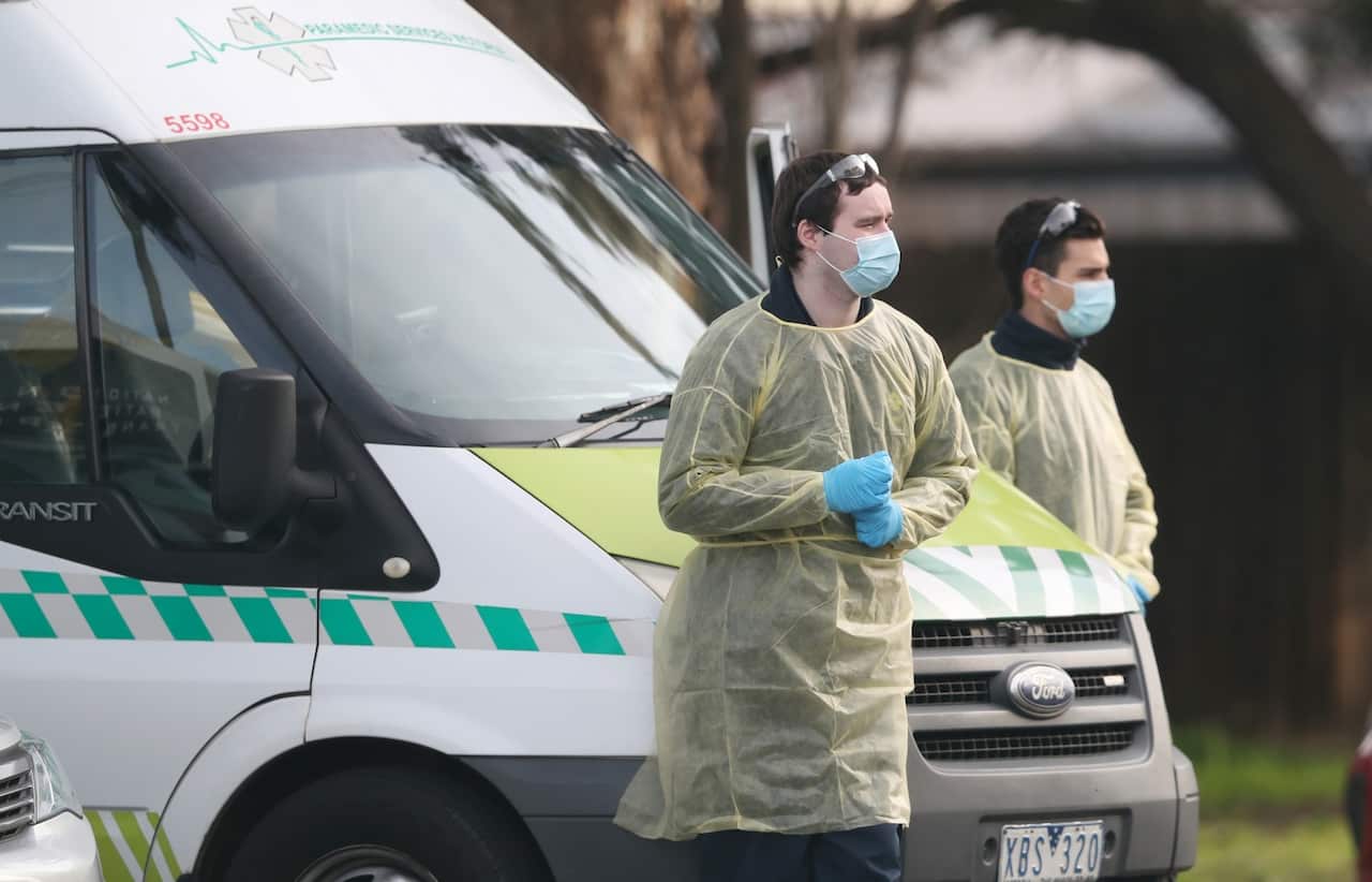 Medical staff are seen preparing to transport people from the St Basils Home for the Aged Care in Fawkner, Victoria.
