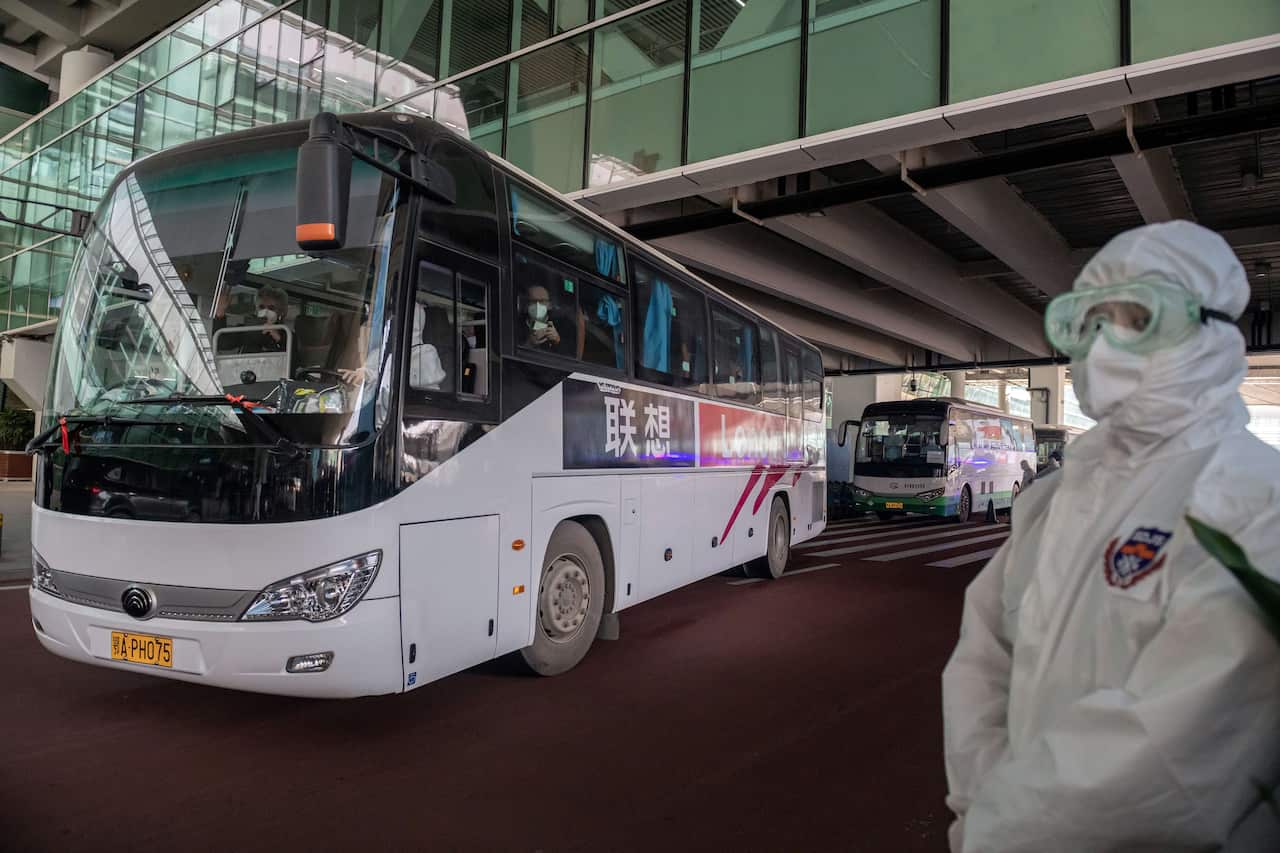 A bus carrying members of the WHO team leaves the airport following their arrival in Wuhan on 14 January. 