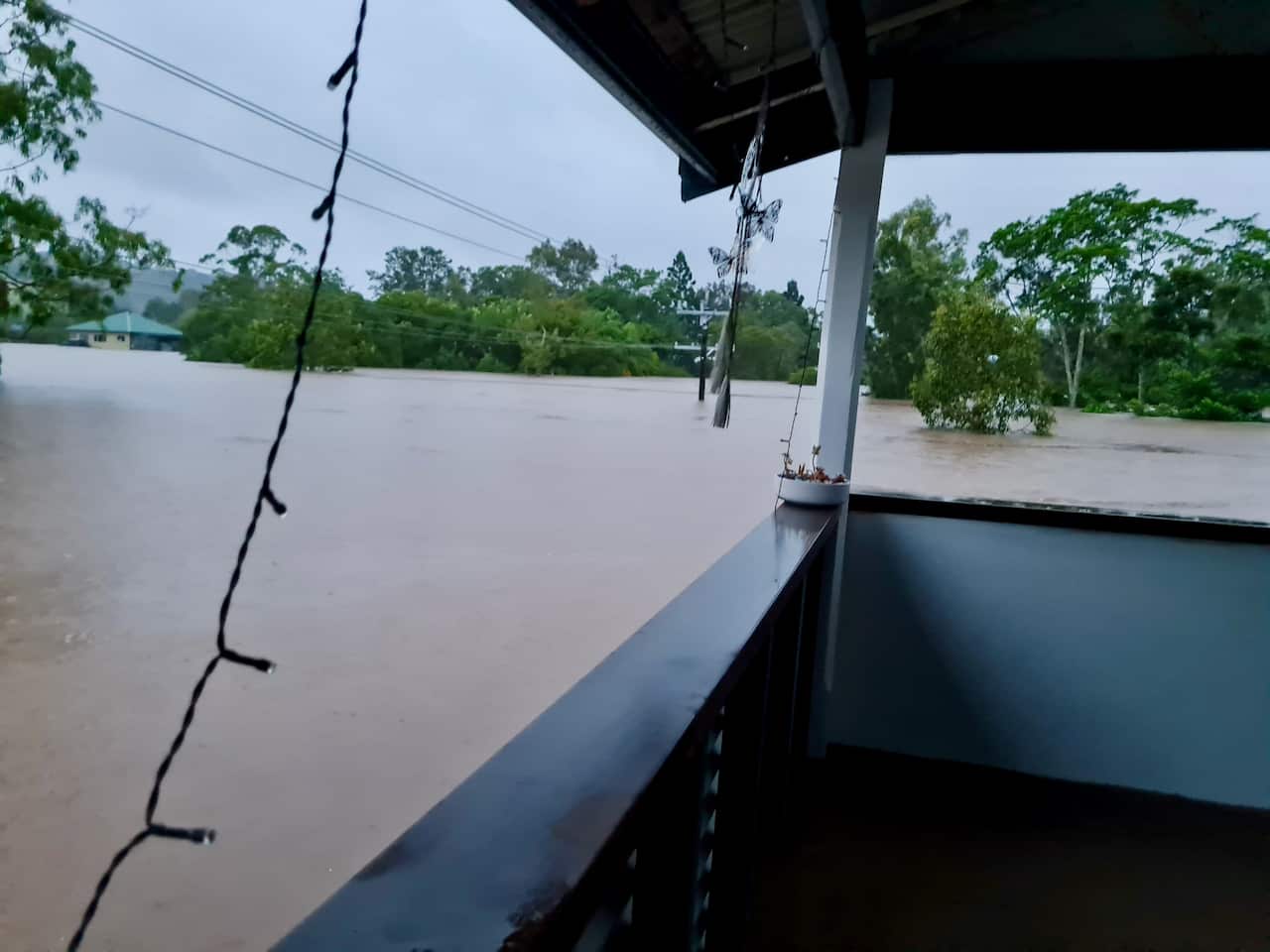 Supattra house surrounded by the flood up to her balcony on the second floor