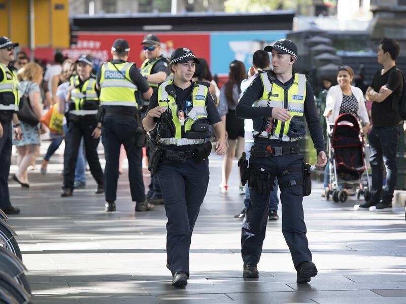 Police walk along Swanston Street