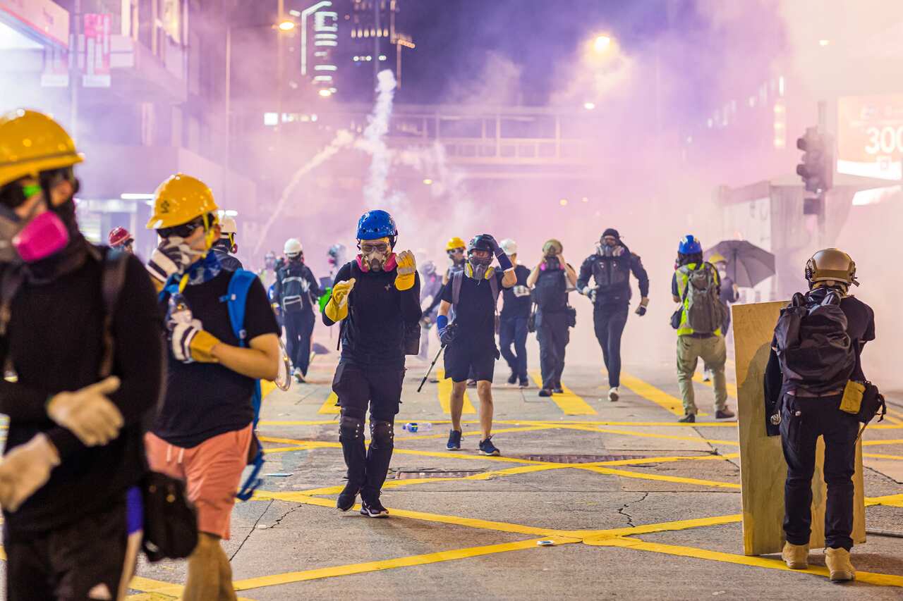 Demonstrators flee from tear gas during the protests against the extradition bill in Hong Kong.