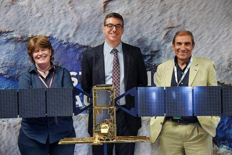 Italian astrophysicists Elena Pettinelli (pictured left), Roberto Orosei (pictured middle) and Enrico Flamini (pictured right) near to a replica of Cosmo-SkyMed radar satellite.