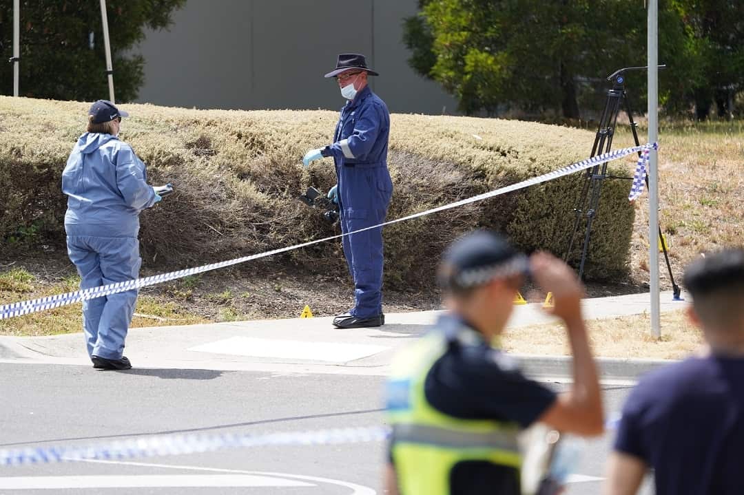Police forensics examine the scene where a woman's body was found this morning. 