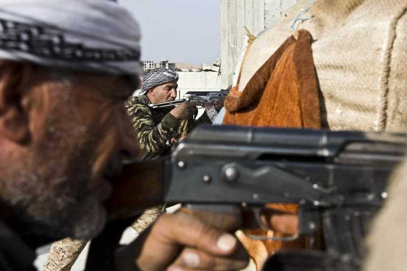 Fighters from the Free Syrian Army, left, and the Kurdish People's Protection Units (YPG) join forces to fight Islamic State group militants in Kobani, Syria.