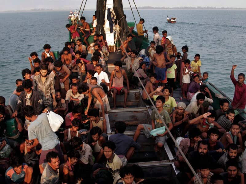 Migrants wait to be rescued off the Indonesian coast