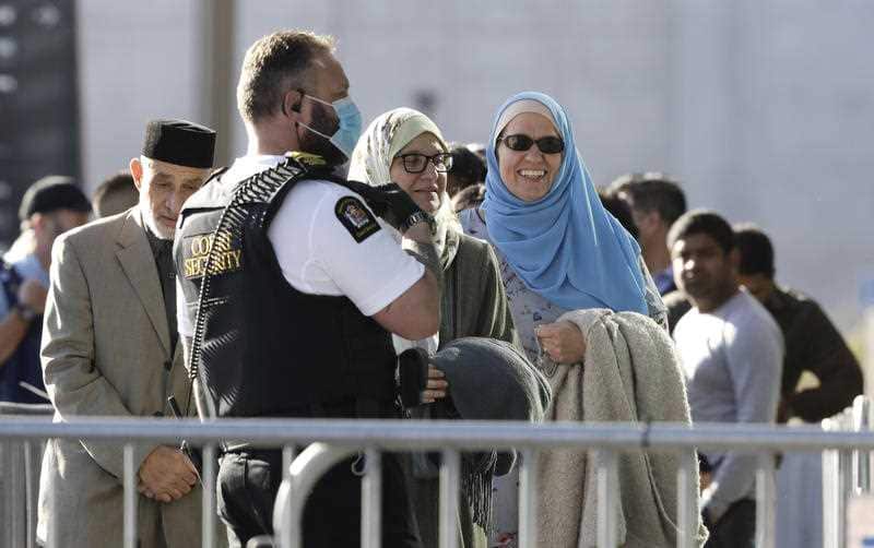 Victims and relatives wait to enter the Christchurch High Court for the final day in the sentencing hearing for the Australian gunman. 