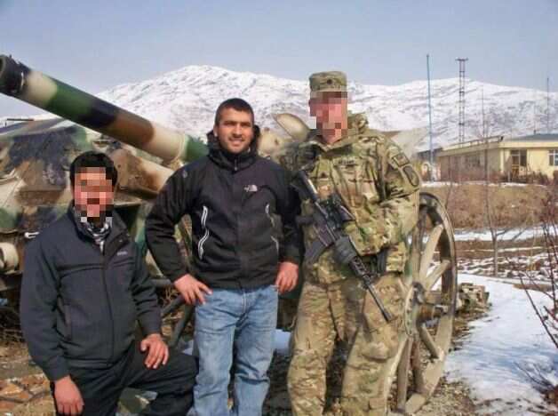 Torialy Raziq, centre, with an Australian soldier in Afghanistan.