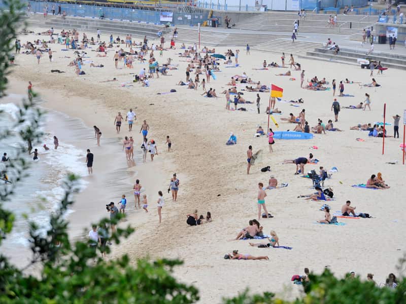 People enjoy the sand at Coogee Beach