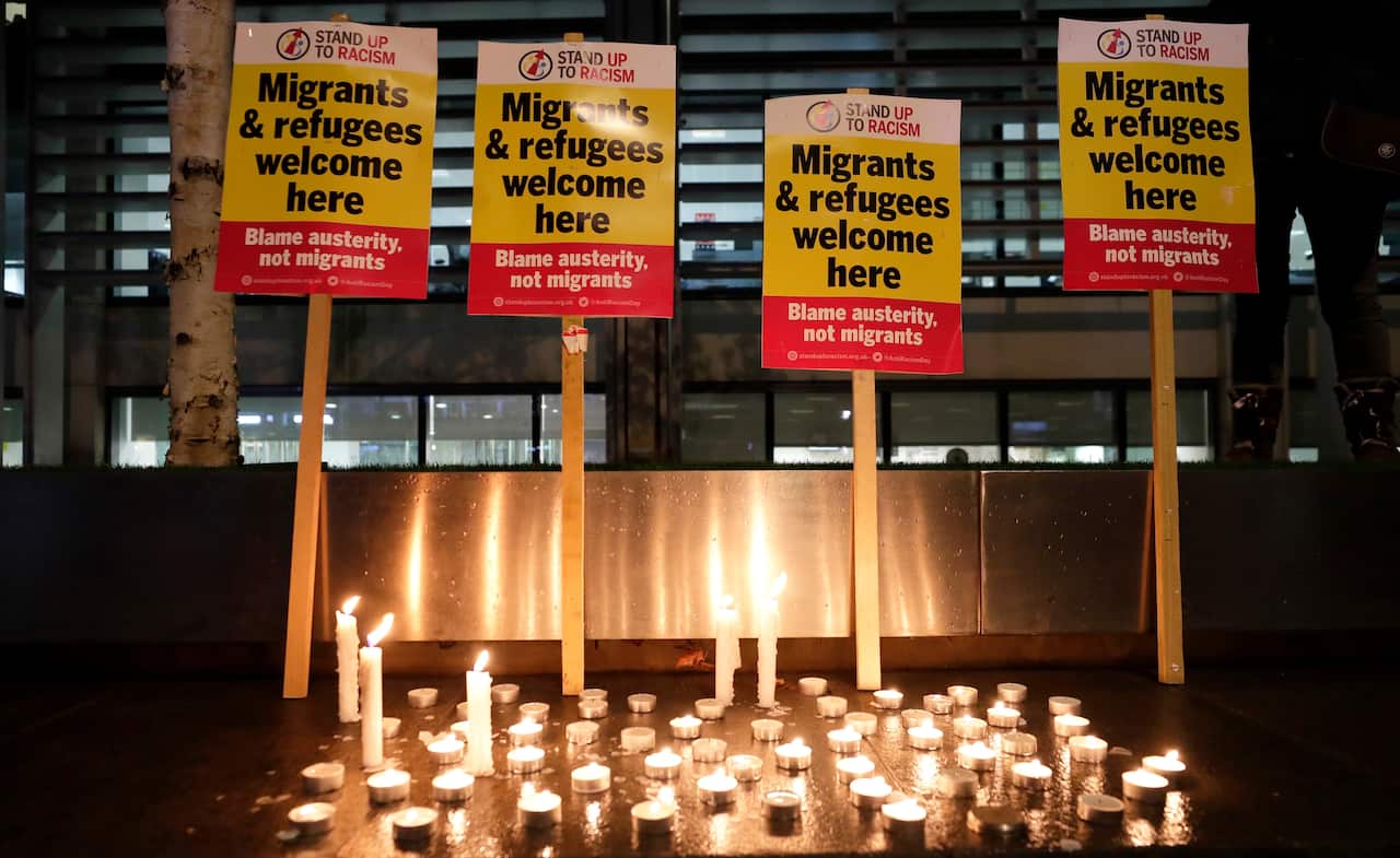 Signs and candles on a wall were placed at a vigil for the 39 lorry victims, outside the Home Office in London.