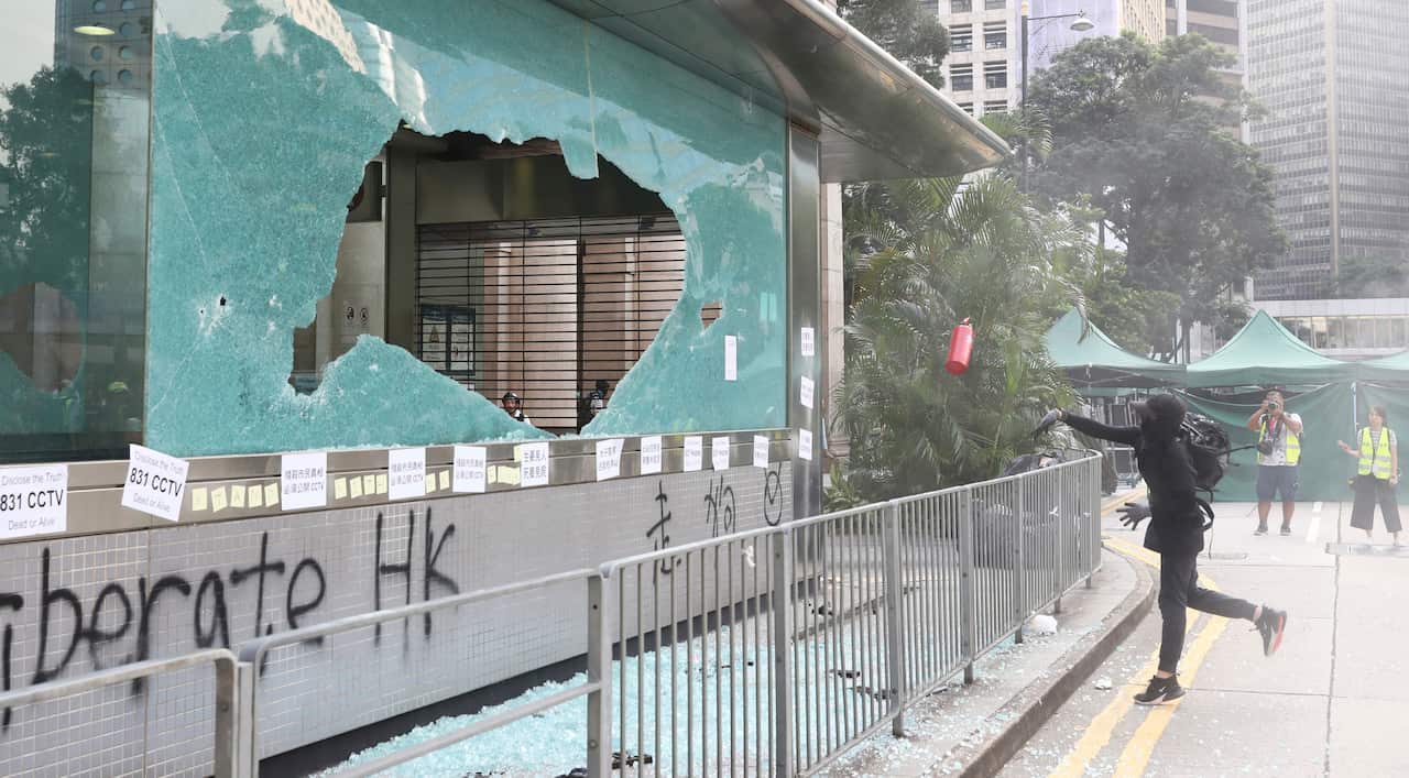 Protesters break the gateway of Mass Transit Railway (MTR) in Hong Kong.