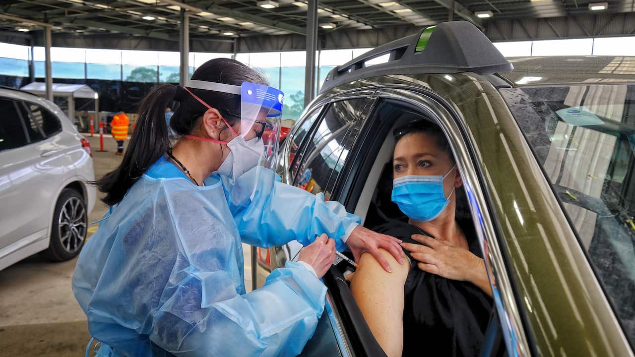 A drive through patient gets vaccinated at the new western health drive through Covid-19 vaccination centre in Melton.