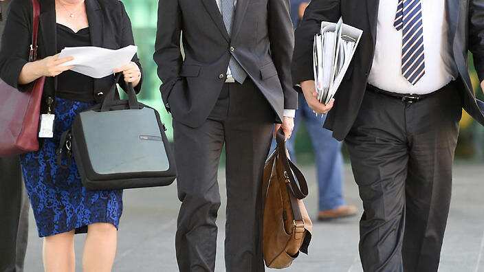 Office workers walk through central Brisbane, Wednesday, May 6, 2015. (AAP Image/Dave Hunt) NO ARCHIVING.