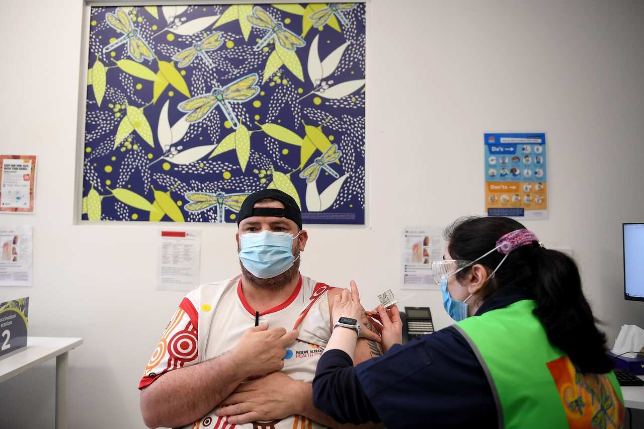 An Indigenous Australian man gets his vaccine. 