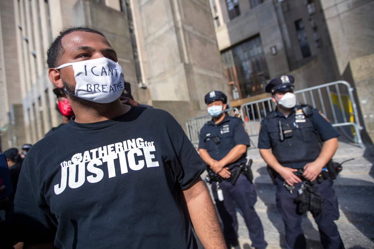 Police and court officers stand guard in front of Manhattan Criminal Court as protesters demonstrate against the the death of George Floyd.