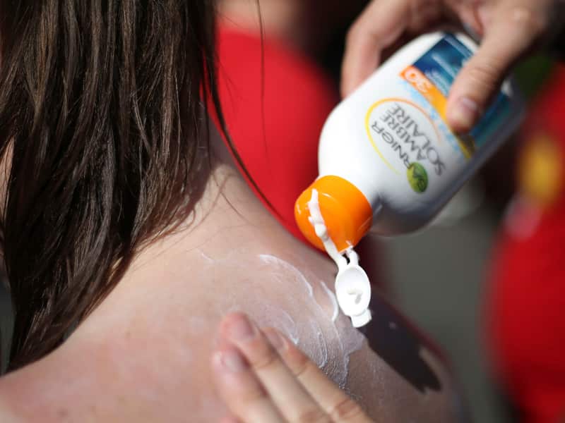 Someone applying suncream