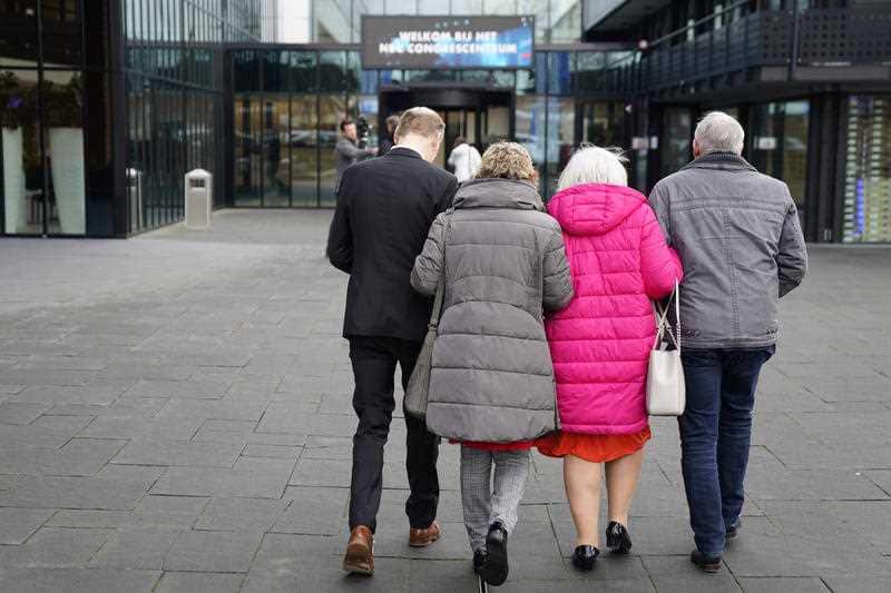 Relatives of victims of MH17 embrace as they arrive to watch a live transmission of the court session at a congress centre in Nieuwegein
