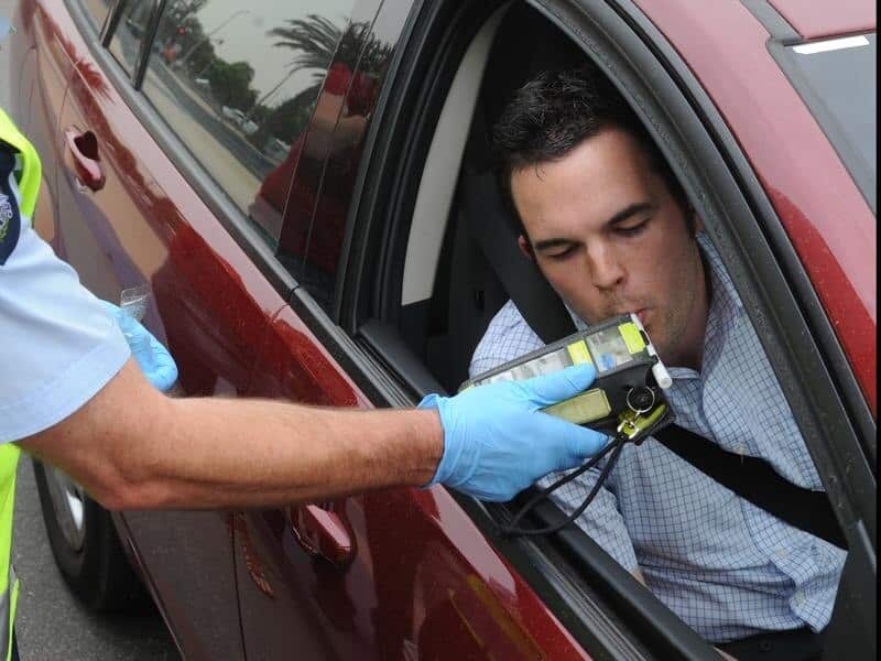 Victoria police conduct a roadside alcohol breath test
