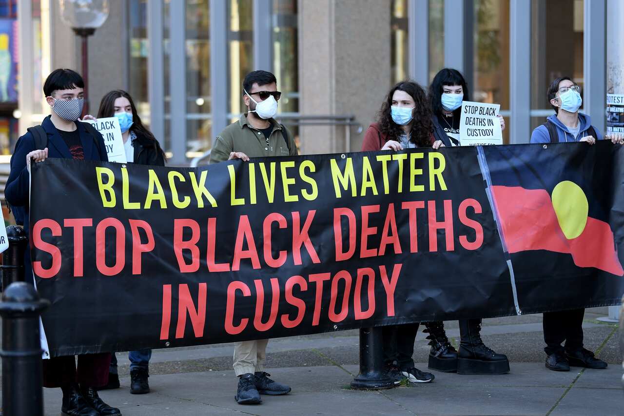 Black Lives Matters supporters are seen during a press conference at the Supreme Court of NSW in Sydney.