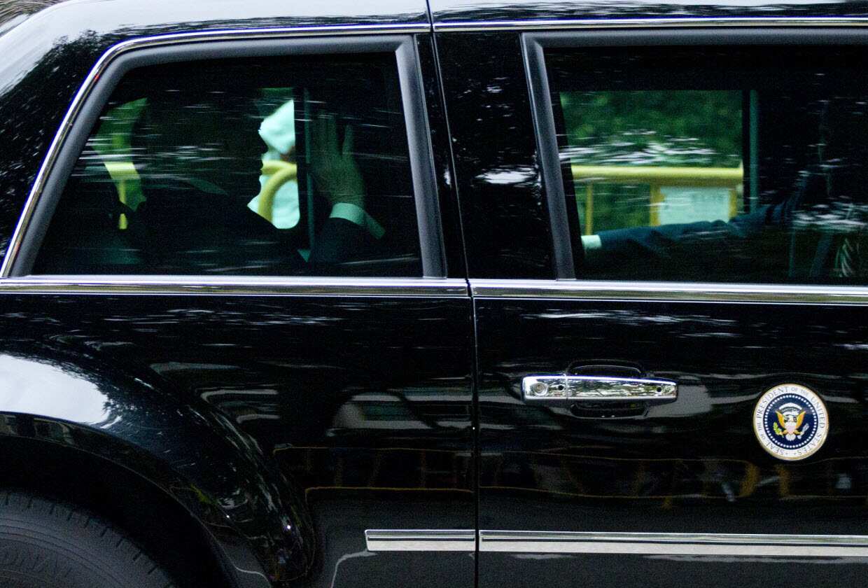 President Donald Trump waves as his motorcade leaves Shangri-La hotel in Singapore Tuesday, June 12.