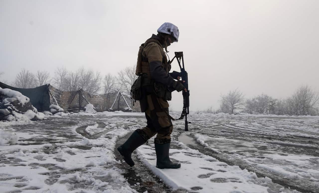 A Ukrainian soldier walks at the line of separation from pro-Russian rebels near Popasna in the Donetsk region, Ukraine