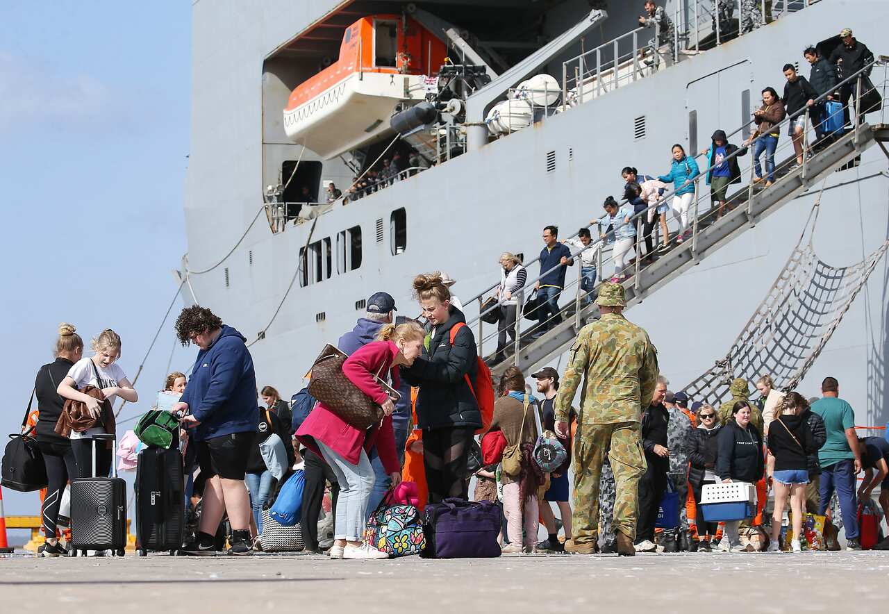 Evacuees from Mallacoota disembark from Naval vessels. 