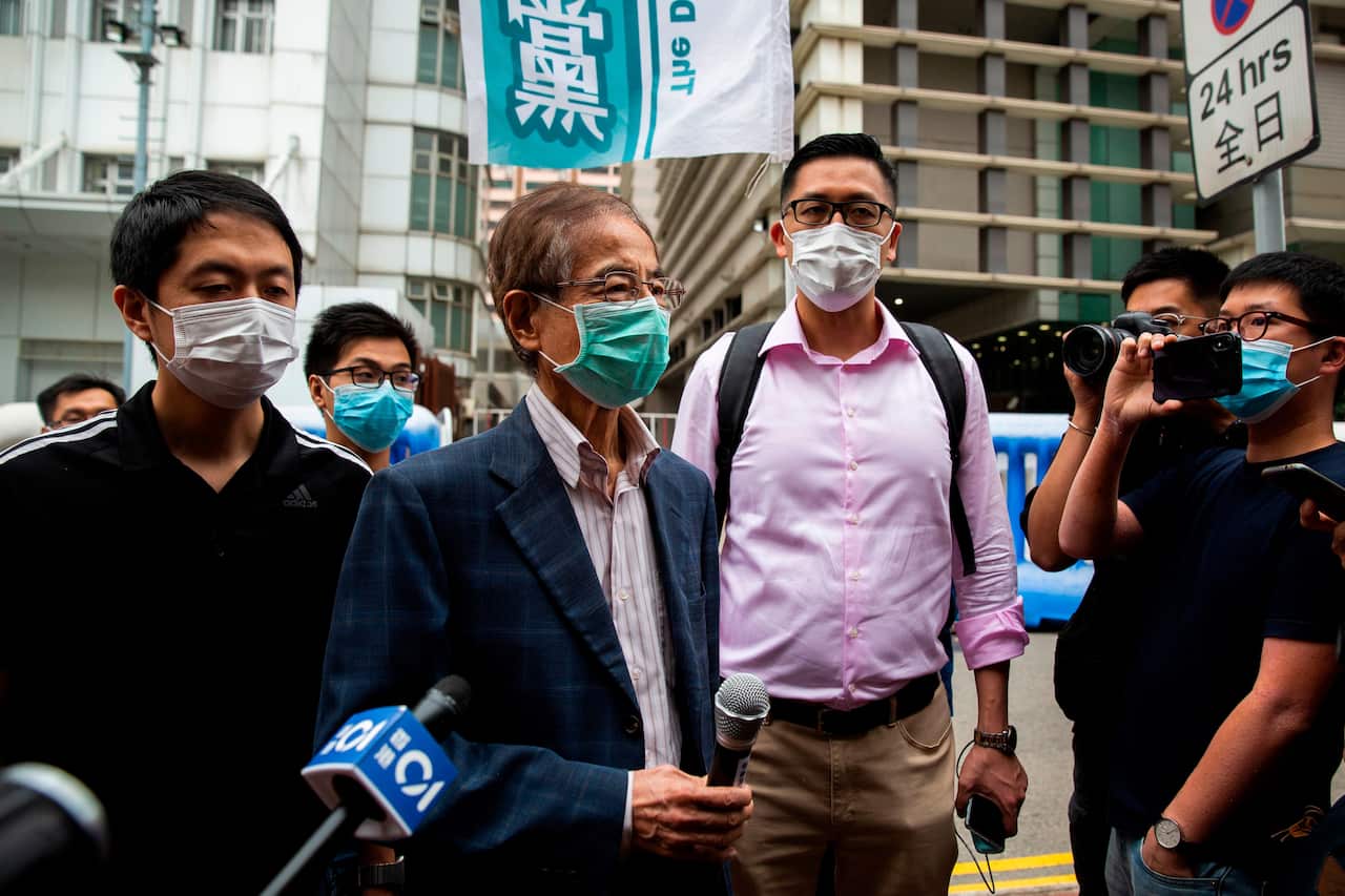 Former lawmaker and pro-democracy activist Martin Lee talks to the media as he leaves the Central District police station in Hong Kong.