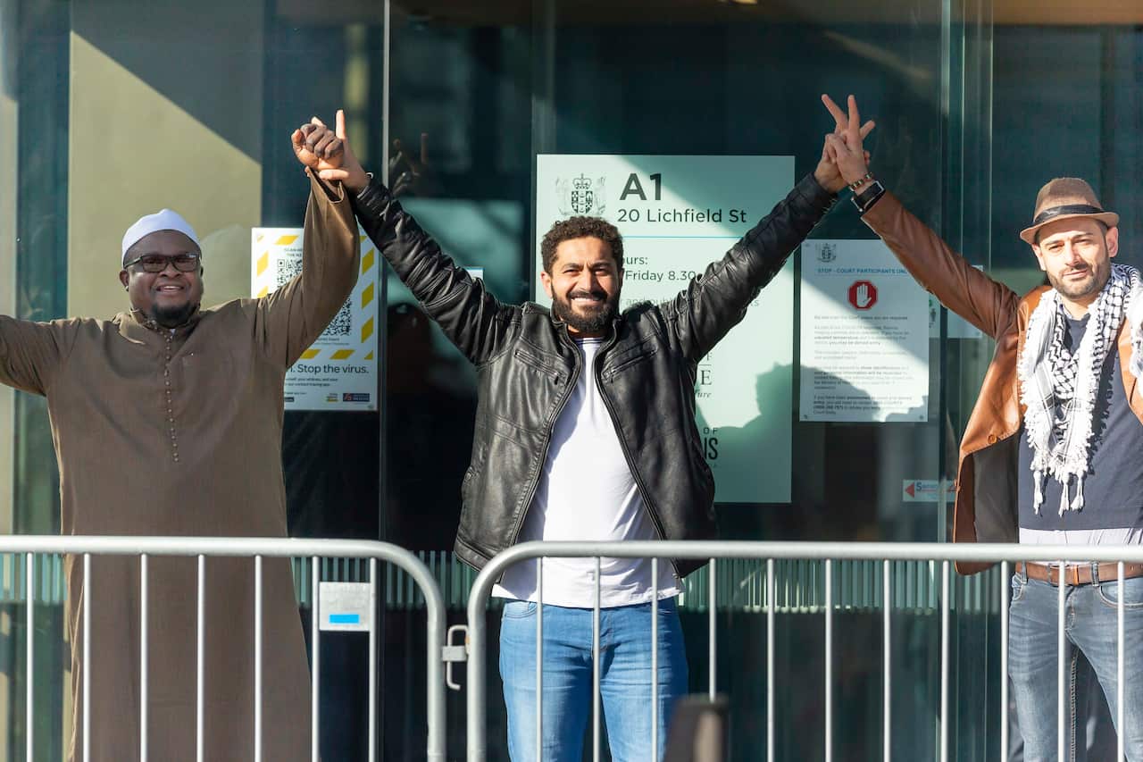 Survivors gesture outside the High Court in Christchurch, New Zealand.
